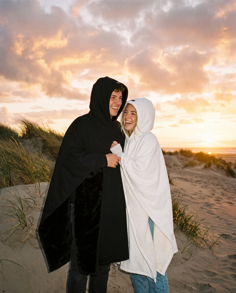 Couple on a winter beach at sunset in midnight and snow Heavy Hugs