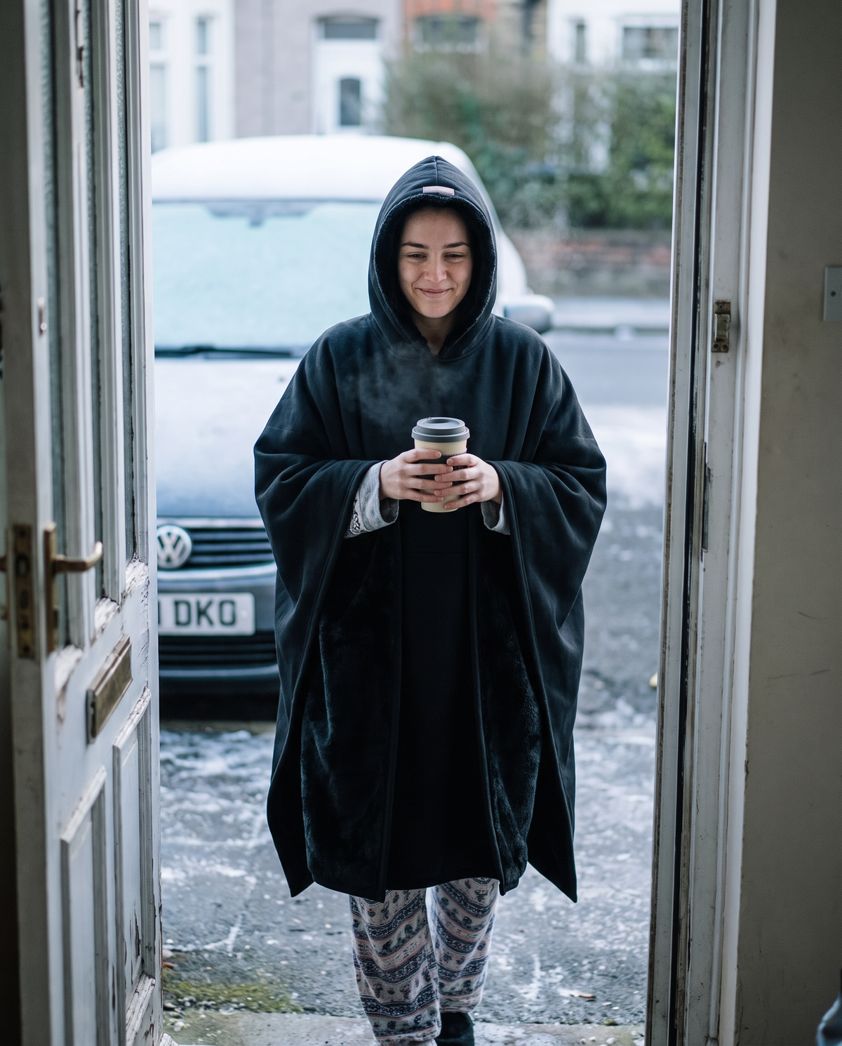 Woman stepping out on a frosty morning in a midnight Heavy Hug over pyjamas