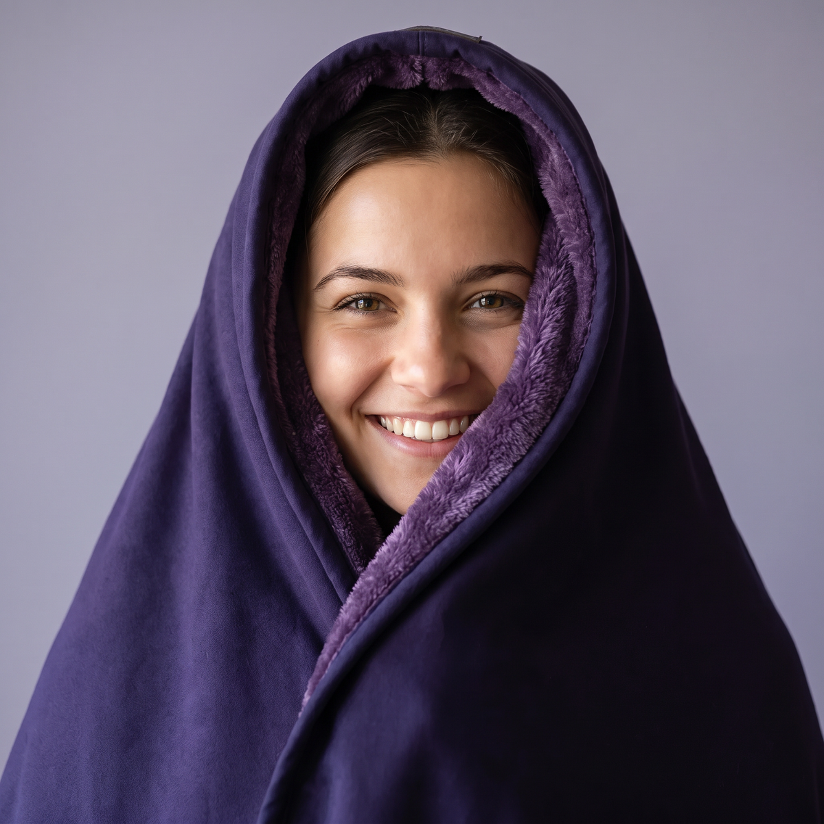 Smiling woman with the deep plum hood pulled down around her face