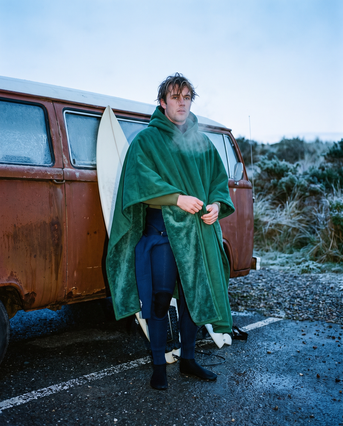 Surfer warming up after a winter surf in a forest green Heavy Hug