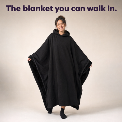 Woman in a black HeavyHug showing the faux-fur lining. The blanket you can walk in.